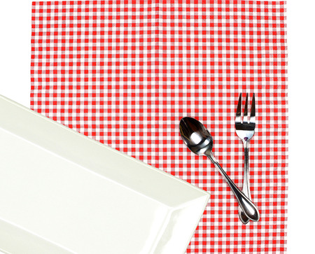 Top view plate with fork and spoon on tablecloth for food serving backgroundの写真素材