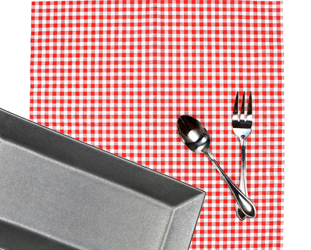 Top view plate with fork and spoon on tablecloth for food serving backgroundの写真素材