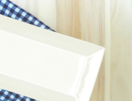 Top view plate on checkered tablecloth pattern background .Free space for products and for your text