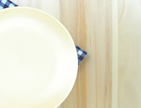 Top view plate on checkered tablecloth pattern background .Free space for products and for your textの写真素材