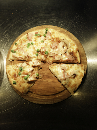 Cut into slices delicious fresh pizza の写真素材
