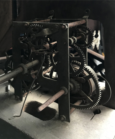 Closeup of an antique vintage gear wheel and ratchet mechanism with springs.