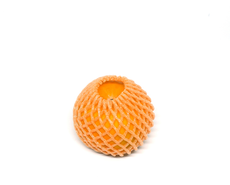 Ripe orange with foam protection net isolated on white backgroundの写真素材