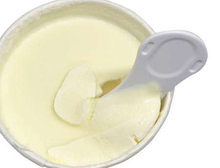 close up ice cream with plastic spoon in paper cupの写真素材