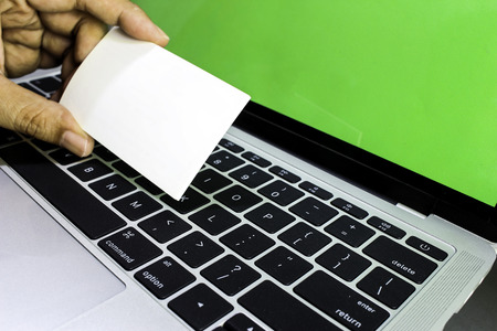 Hands using laptop and check business cards for calling online shopping