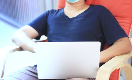 Coronavirus. Business man working from home wearing hygienic face mask for covid-19 virus protection