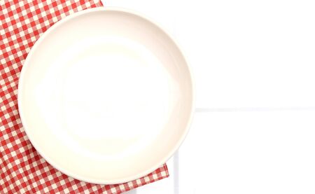 plate on tablecloth on white backgroundの写真素材