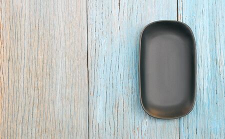 black plate on wood table backgroundの写真素材
