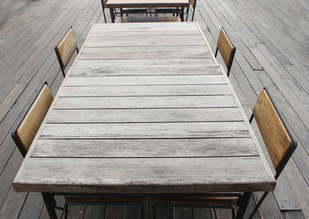 Empty outdoor old vintage wood table and chair in coffee shop restaurantの写真素材