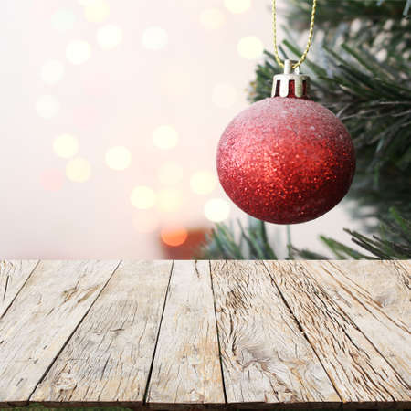 christmas tree with decorations ball gift with light bokeh background on wood floorの写真素材