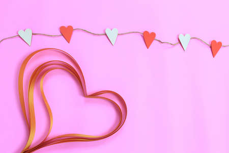 red and white hearts hanging on a rope for and ribbon heart for valentines day concept