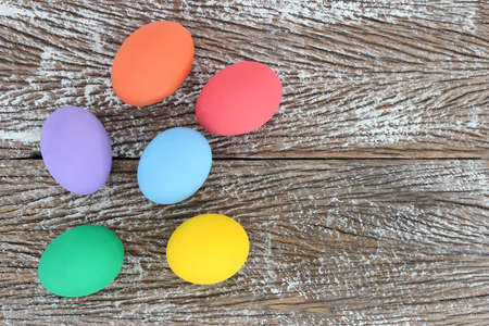 Easter eggs on wooden background with space