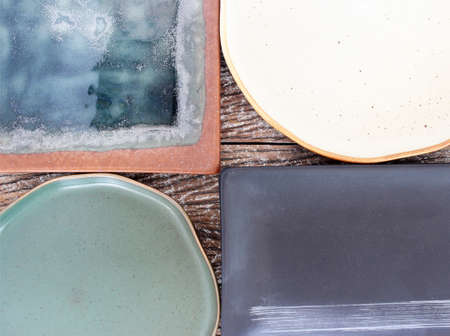 Empty modern ceramic plate on wood table background ,top view