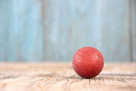 Red Christmas ball on wood table backgroundの写真素材