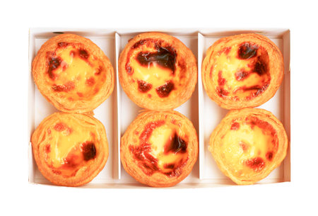 Egg tarts in a paper tray isolated on white background