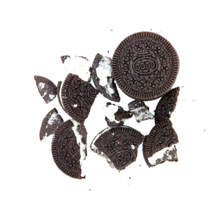 Sandwich chocolate cookies with a sweet cream with crumbs isolated on white backgroundの写真素材