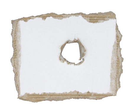 A piece of paper is torn with a hole isolated on white backgroundの写真素材