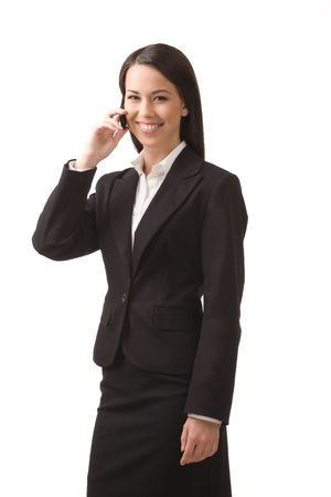 Young, successful business woman with a cell phone isolated on a white background.の写真素材
