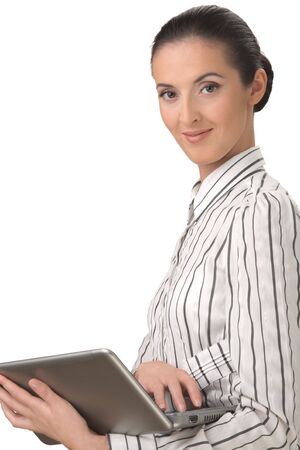 Portrait on a white background of the young, smiling woman holding the laptop.の写真素材