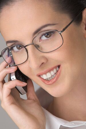 The young beautiful woman in points, smiling, speaks by phone.の写真素材