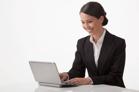 The young woman joyfully with pleasure works on a computerの写真素材