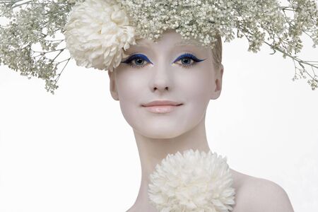 Model in an image of the winter, created by means of a make-up, Body- Art and floristics art on white backgroundの写真素材