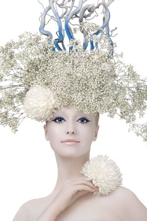 Model in an image of the winter, created by means of a make-up, Body-Art and floristics art on a white background.の写真素材