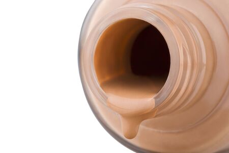 The decorative cosmetics follows from glass bottle, close-up on white background.の写真素材