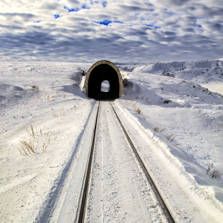 Snowy railway landscape. Cloudy weather.A small train tunnelの写真素材