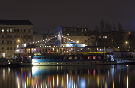 Hostel ships at River Spree Berlin by night. Near Eastside Gallery. Multiple colored lightsのeditorial素材