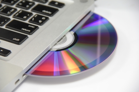 cd or dvd disk in the drive of a laptopの写真素材