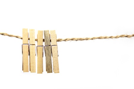Wooden clothes clips isolated on ropeの写真素材