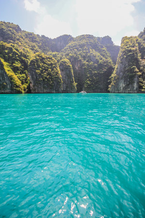 Cliff and the clear sea on phi phi bay ,krabi,thailandの写真素材