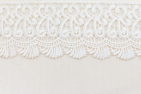 Lace flowers frame close up isolated on Fabric textureの写真素材