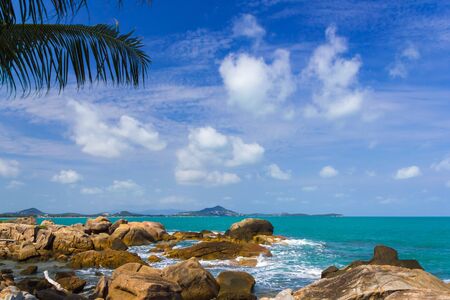 Wave splash breaking on the shore with sea foamの写真素材