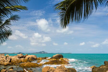 Wave splash breaking on the shore with sea foamの写真素材