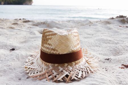 Woven hat on the beach in the morning