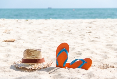 flip-flop and a woven hat on the sand beach.の写真素材