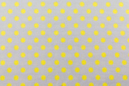 White Fabric and yellow Tiny Polka Dots Backgroundの写真素材