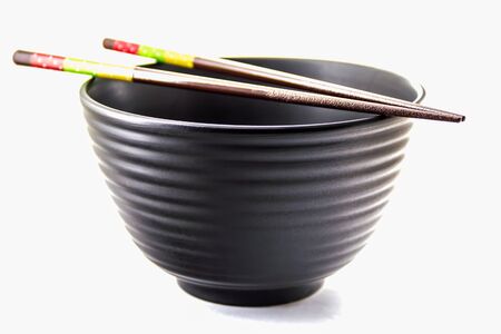 Black Bowl and chopsticks on top isolate on whiteの写真素材