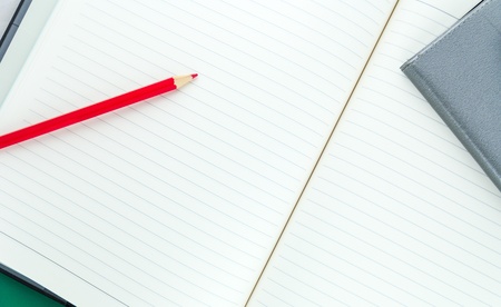 Pencil and notebook isolated on white background