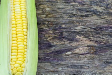 Ripe corn on a wooden tableの写真素材