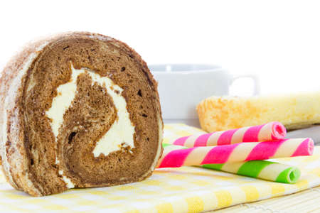 Chocolate roll and Wafer rolls  on yellow tableclothの写真素材