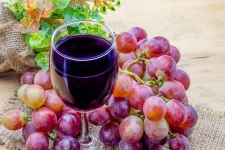 Glass of grape juice and grape fruitの写真素材