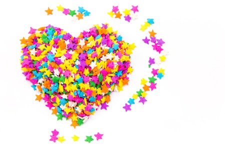 Heart shaped made from colored sprinklesの写真素材