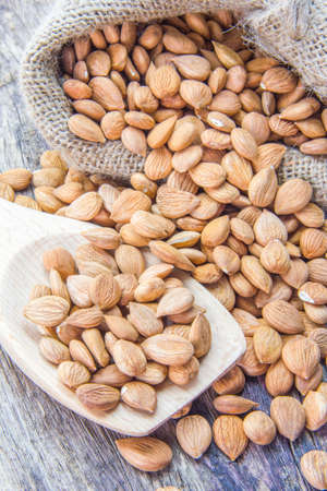 Almonds on wooden spoonの写真素材