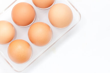 Chicken eggs in box isolate on white
