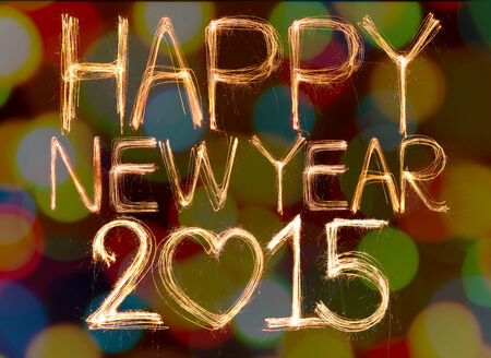Happy new year 2015 written with Sparkling figures on bokeh backgroundの写真素材