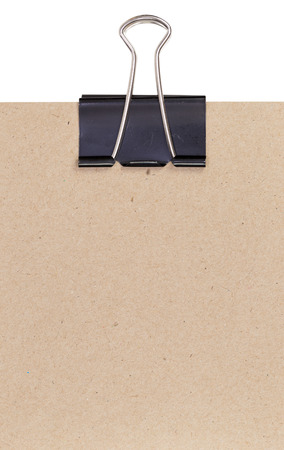 Close up of a binder clip attached to sheet of paperの写真素材