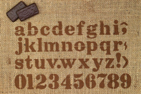 chocolate alphabet on sack backgroundの写真素材